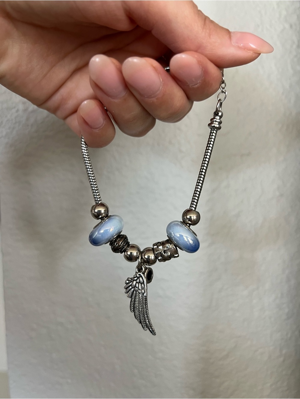 Silver-Tone Bracelet with Light Blue Glass Beads and Wing Charm